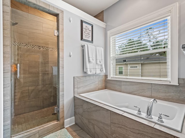 bathroom featuring separate shower and tub