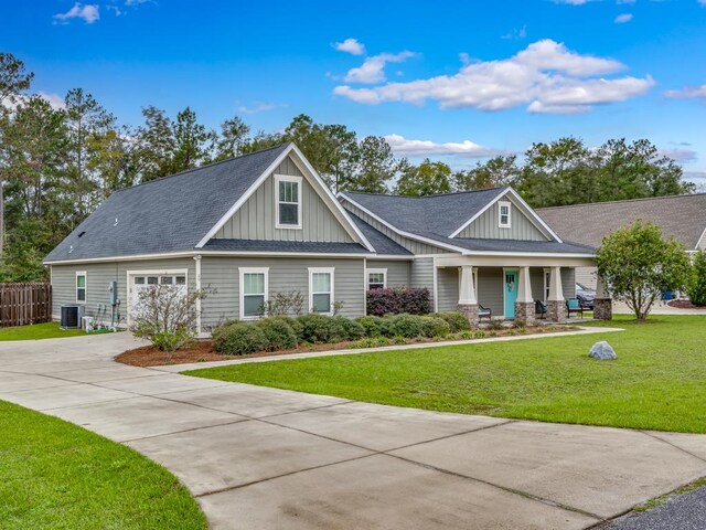 craftsman house with central air condition unit, a front lawn, and a porch