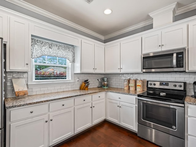 kitchen with light stone countertops, stainless steel appliances, white cabinetry, and dark hardwood / wood-style floors