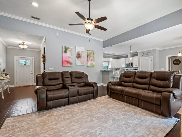 living room with crown molding, light hardwood / wood-style flooring, and ceiling fan