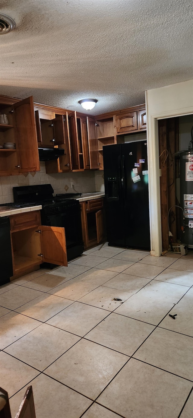 kitchen featuring a textured ceiling, black appliances, and decorative backsplash