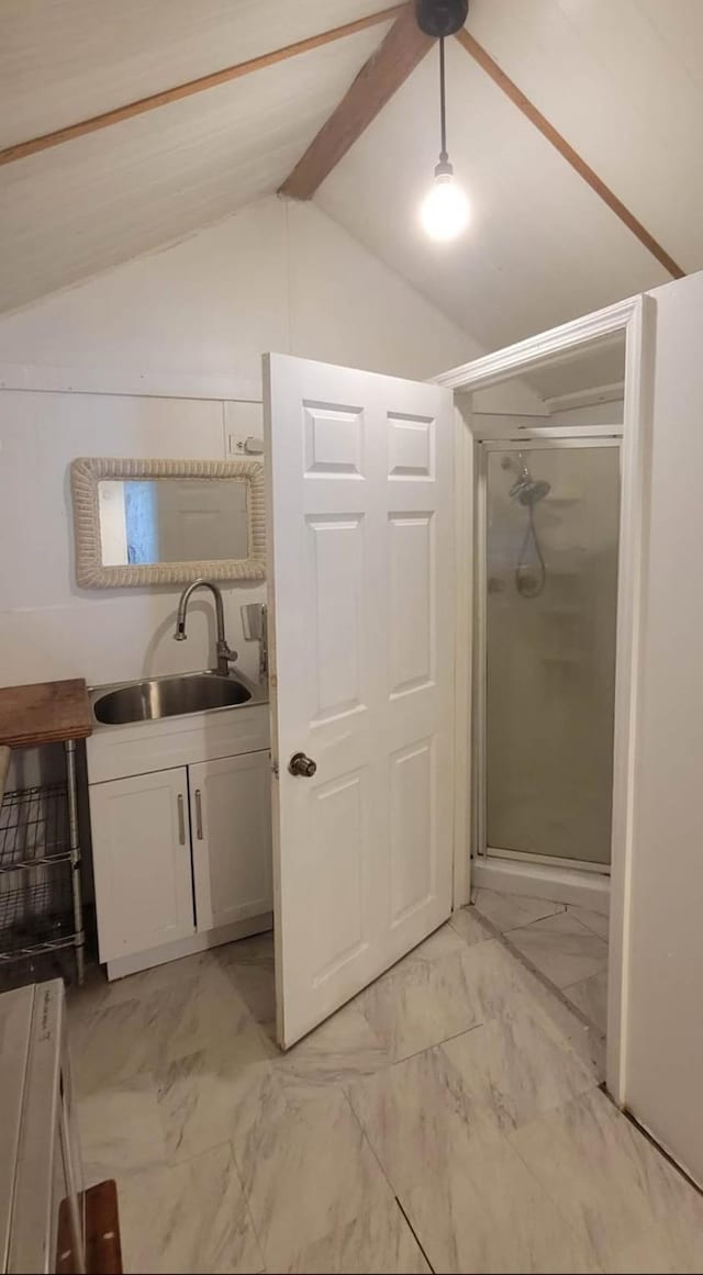 bathroom featuring vaulted ceiling with beams, a stall shower, marble finish floor, and vanity