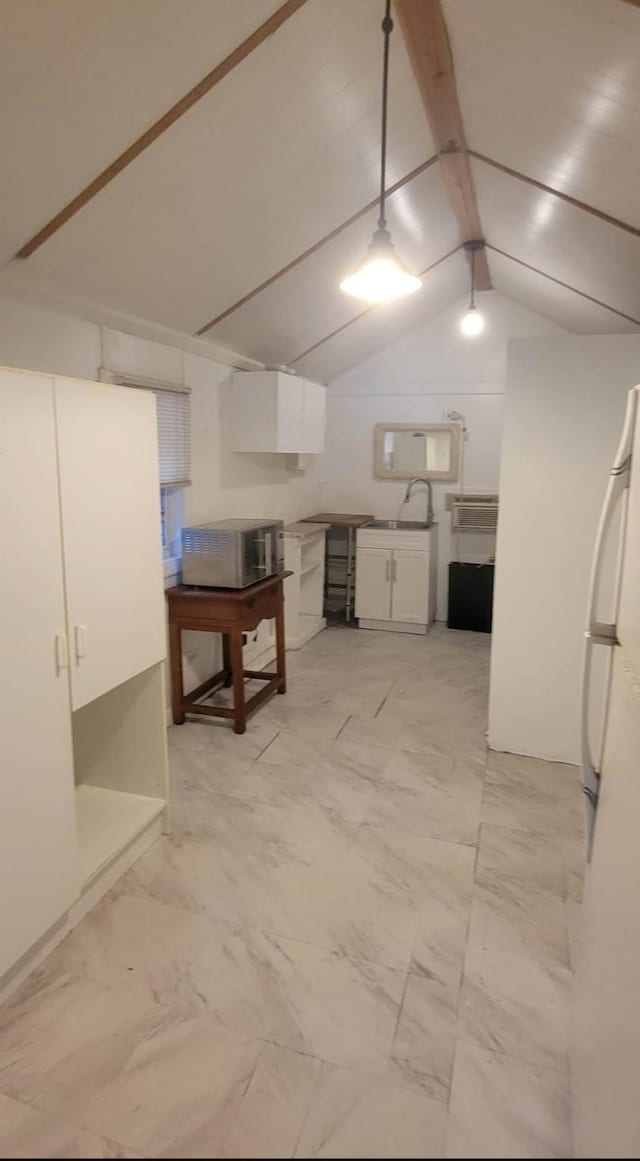 interior space with marble finish floor, a sink, and freestanding refrigerator