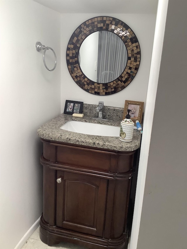 bathroom featuring baseboards and vanity