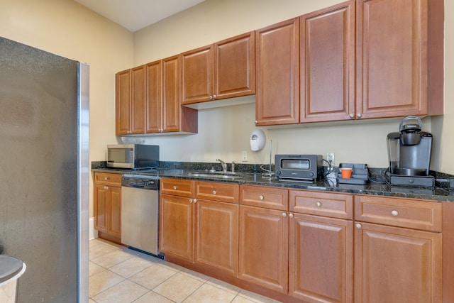 121 N Monroe St Unit 1103, Tallahassee, FL 32301 - kitchen with appliances with stainless steel finishes, light tile patterned floors, dark stone countertops, and a sink