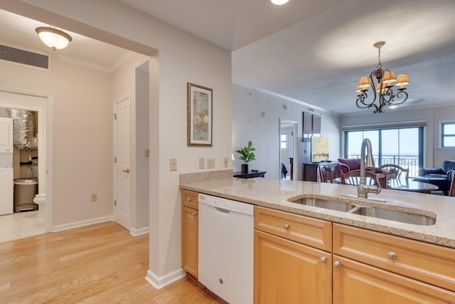 121 N Monroe St Unit 1103, Tallahassee, FL 32301 - kitchen with dishwasher, a sink, stacked washer and clothes dryer, ornamental molding, and light stone counters