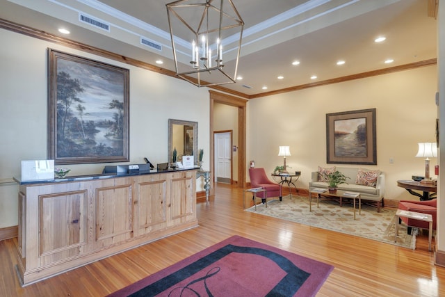 121 N Monroe St Unit 1103, Tallahassee, FL 32301 - living area featuring ornamental molding, light wood-style flooring, baseboards, a chandelier, and a tray ceiling