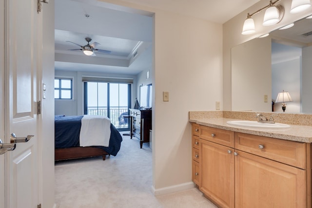 121 N Monroe St Unit 1103, Tallahassee, FL 32301 - ensuite bathroom with vanity, a tray ceiling, a ceiling fan, and baseboards