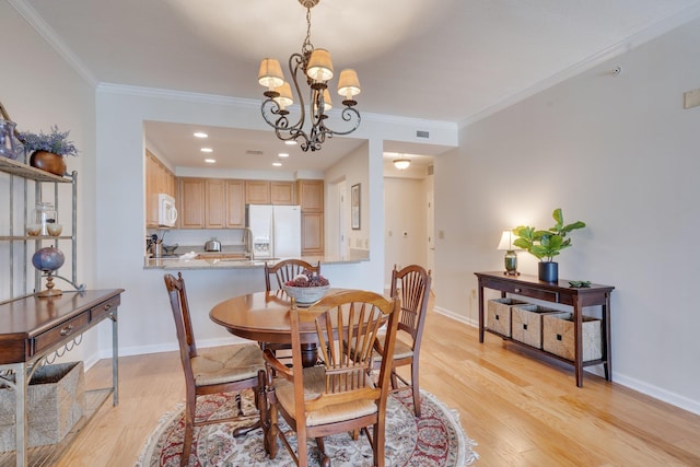 121 N Monroe St Unit 1103, Tallahassee, FL 32301 - dining room with light wood finished floors, crown molding, a chandelier, baseboards, and recessed lighting
