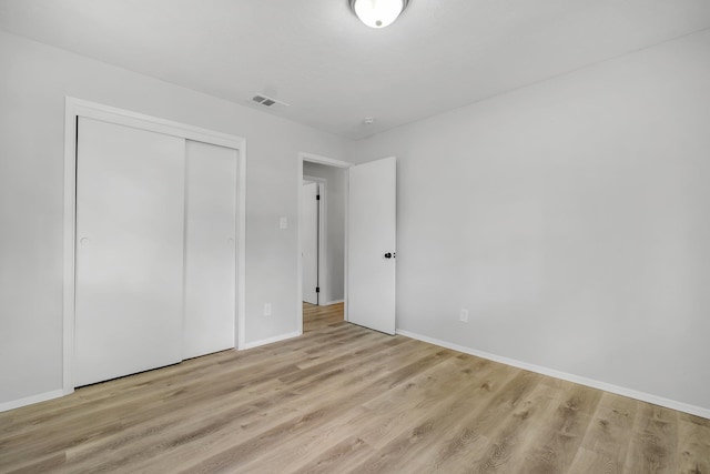 319 Meadowbrook Ln, Tallahassee, FL 32304 - unfurnished bedroom with wood finished floors, baseboards, and a closet
