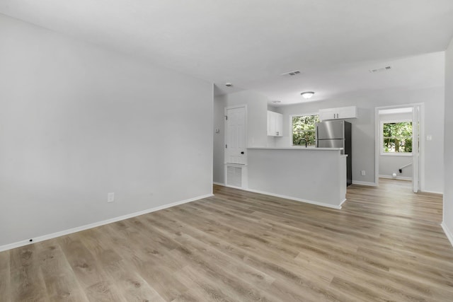 319 Meadowbrook Ln, Tallahassee, FL 32304 - unfurnished living room featuring baseboards and light wood finished floors