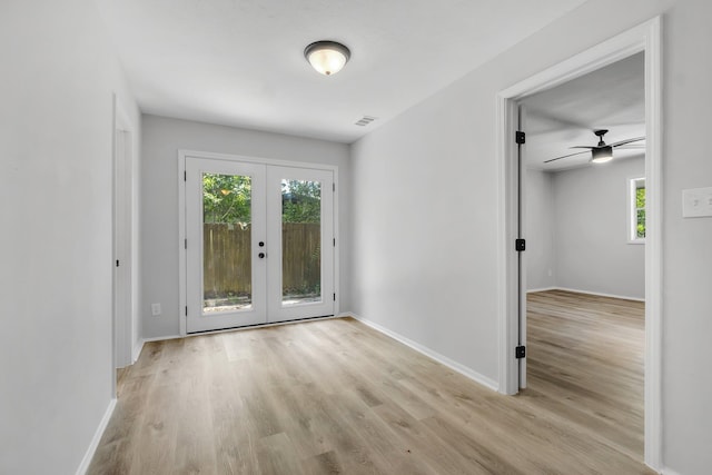 319 Meadowbrook Ln, Tallahassee, FL 32304 - empty room with wood finished floors, a ceiling fan, french doors, and baseboards