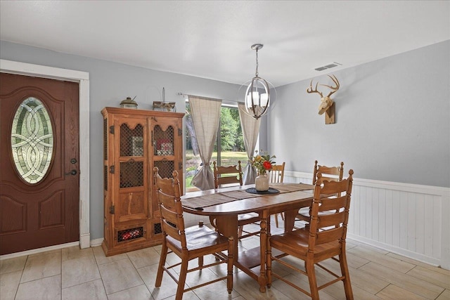 147 Hawk Ridge Dr, Havana, FL 32333 - dining space featuring a chandelier and a wainscoted wall
