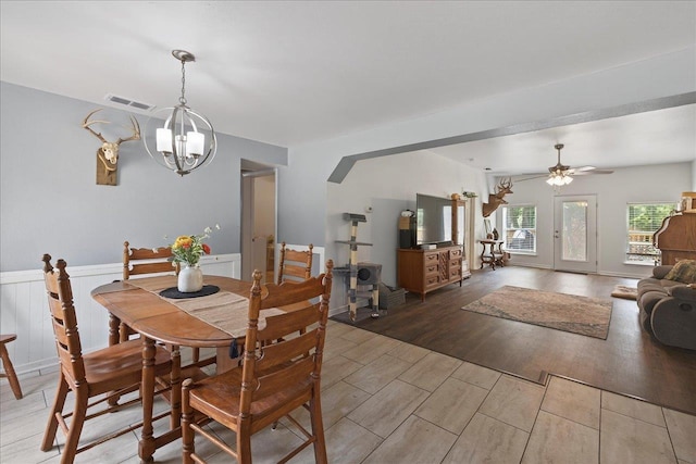 147 Hawk Ridge Dr, Havana, FL 32333 - dining space featuring a chandelier, light wood-style floors, a wainscoted wall, ceiling fan, and arched walkways
