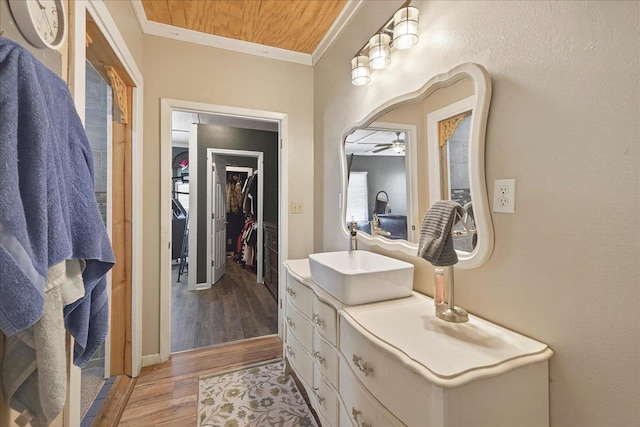 147 Hawk Ridge Dr, Havana, FL 32333 - bathroom featuring ornamental molding, vanity, wood finished floors, a walk in closet, and a ceiling fan