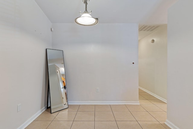 spare room featuring light tile patterned flooring