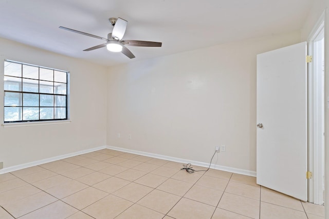 tiled spare room featuring ceiling fan