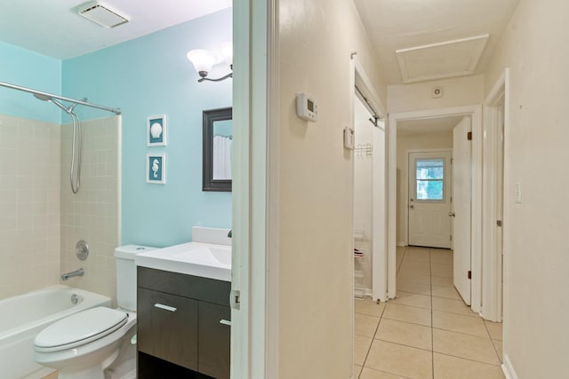 full bathroom featuring vanity, tile patterned flooring, toilet, and tiled shower / bath combo