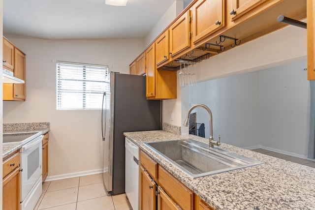 kitchen featuring sink, white appliances, light tile patterned flooring, and light stone counters