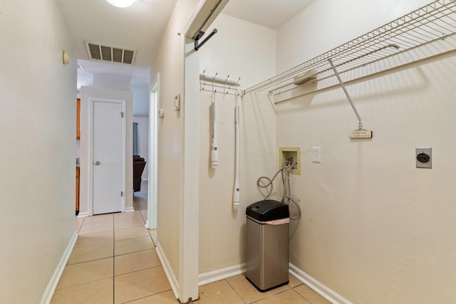 laundry area featuring electric dryer hookup, hookup for a washing machine, and light tile patterned flooring