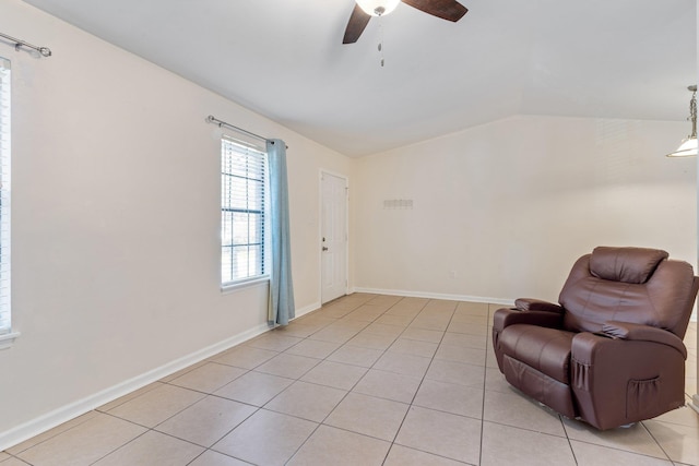 sitting room featuring ceiling fan, light tile patterned flooring, and vaulted ceiling