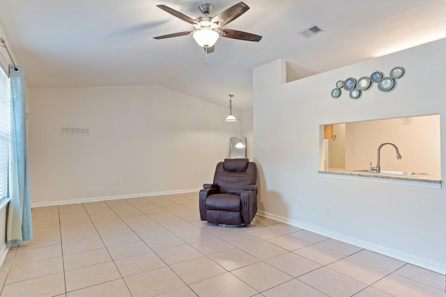 unfurnished room with lofted ceiling, ceiling fan, light tile patterned floors, and sink