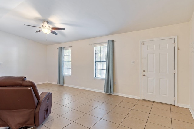 sitting room featuring light tile patterned flooring and ceiling fan