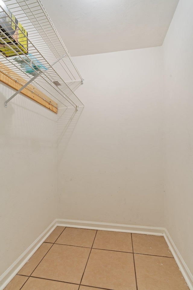 spacious closet with tile patterned floors