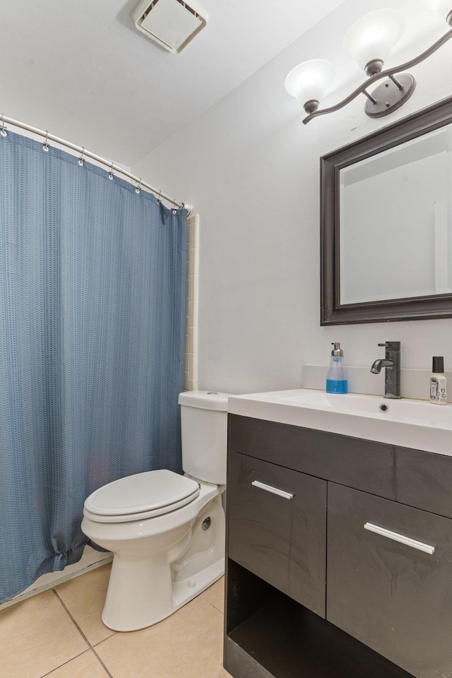 bathroom featuring toilet, tile patterned flooring, curtained shower, and vanity