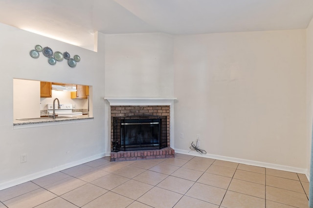 unfurnished living room featuring light tile patterned flooring and a brick fireplace