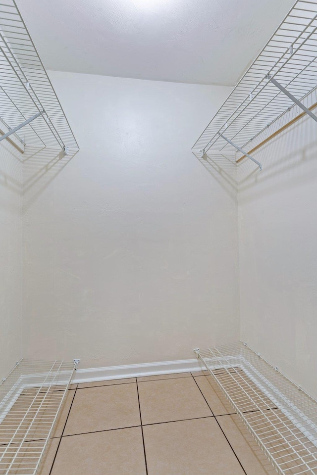 spacious closet featuring tile patterned flooring