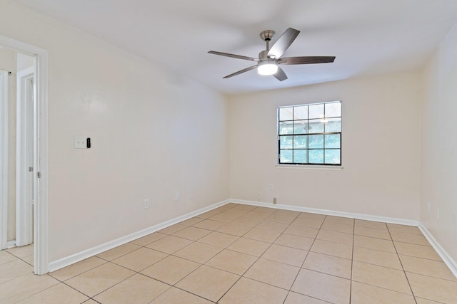 tiled spare room featuring ceiling fan