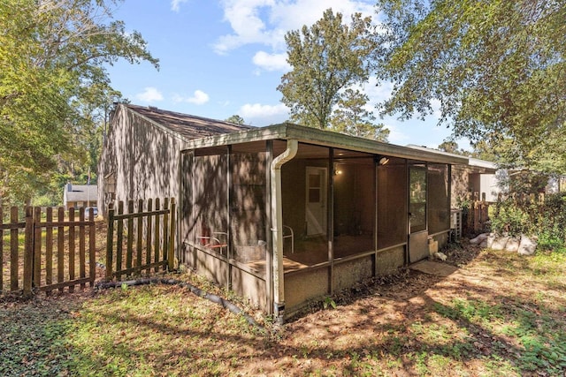 view of property exterior featuring a sunroom