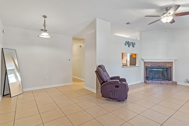 unfurnished room with light tile patterned flooring, a brick fireplace, ceiling fan, and vaulted ceiling