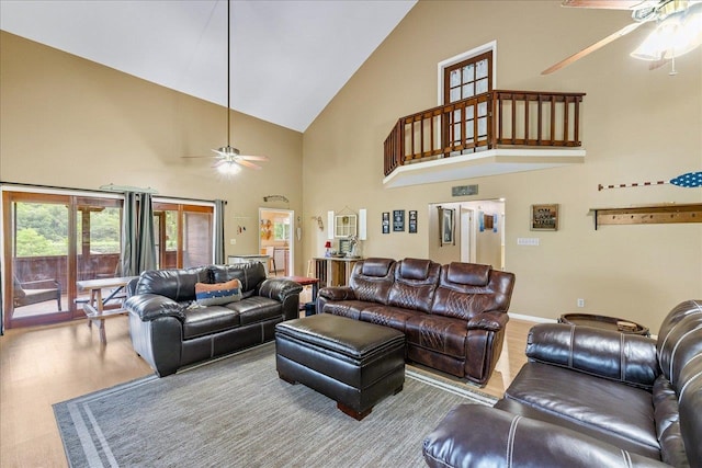 living room featuring high vaulted ceiling, wood-type flooring, and ceiling fan