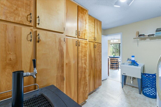 interior space featuring a textured ceiling and cabinets