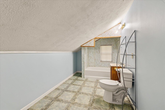 bathroom with toilet, a washtub, vanity, and a textured ceiling