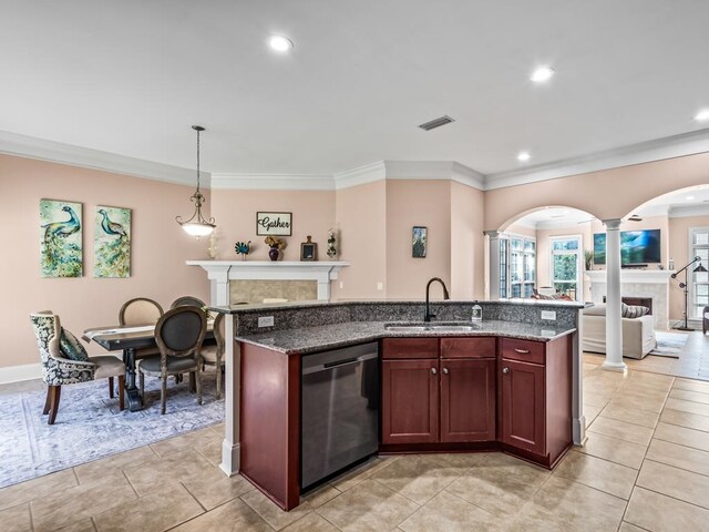 kitchen with sink, a kitchen island with sink, stainless steel dishwasher, decorative light fixtures, and dark stone countertops