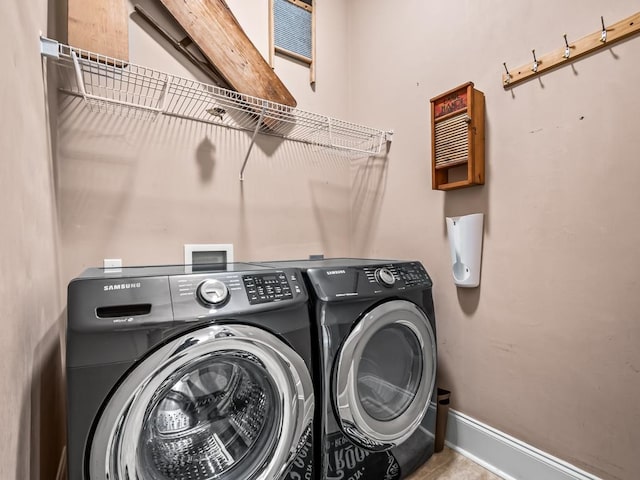 clothes washing area featuring separate washer and dryer