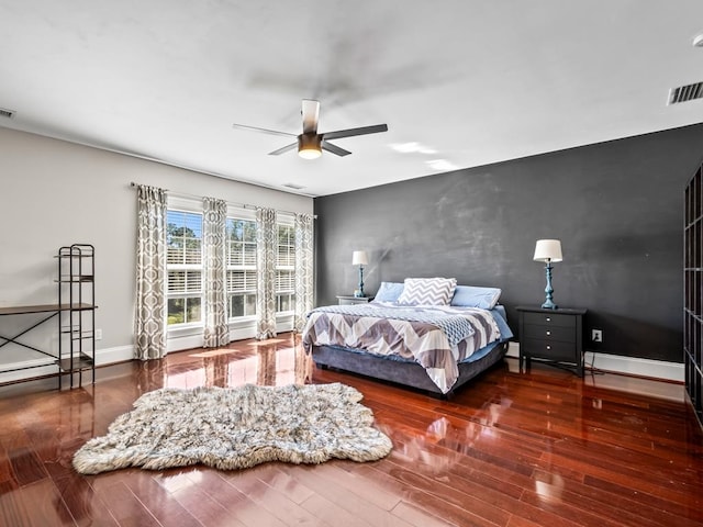 bedroom with dark wood-type flooring and ceiling fan