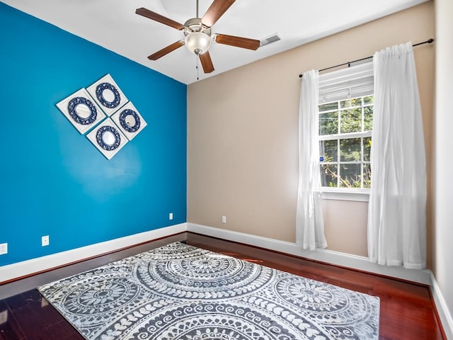 unfurnished room featuring hardwood / wood-style flooring and ceiling fan