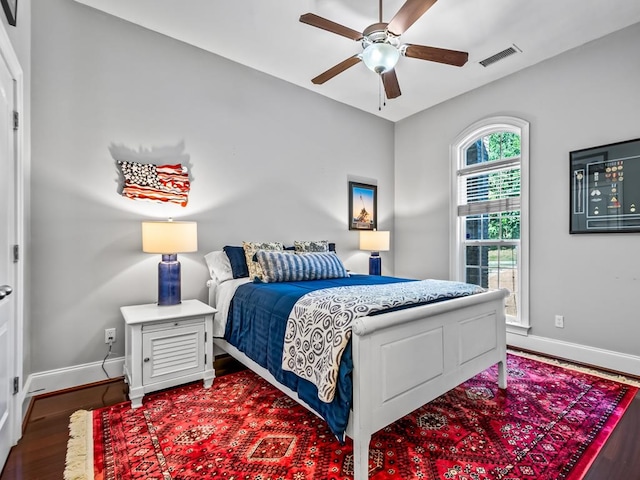 bedroom with ceiling fan and dark hardwood / wood-style flooring