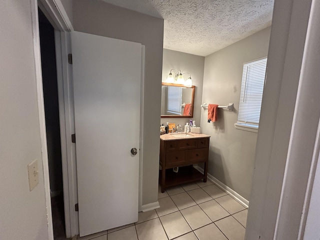 bathroom featuring a textured ceiling, vanity, and tile patterned flooring