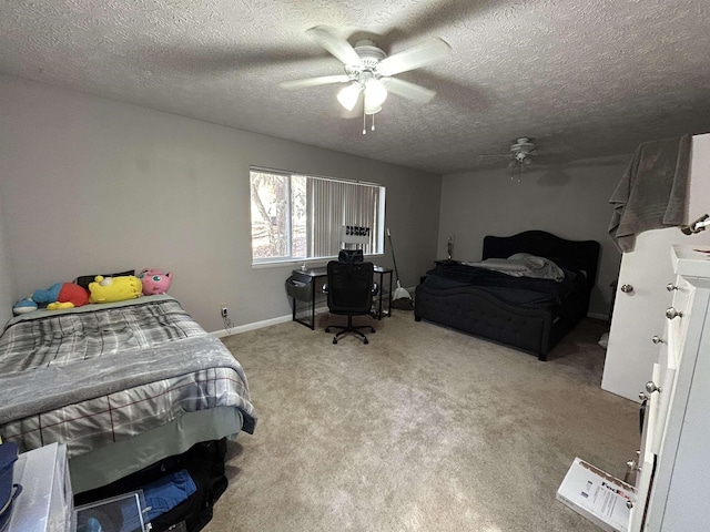 bedroom with ceiling fan, light carpet, and a textured ceiling