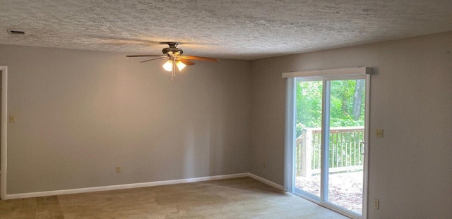 spare room featuring ceiling fan and a textured ceiling