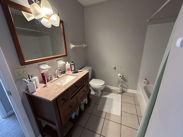 bathroom featuring vanity, tile patterned flooring, a bathtub, and toilet