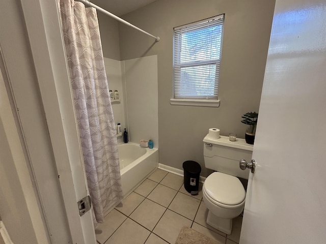 bathroom featuring toilet, tile patterned flooring, and shower / tub combo