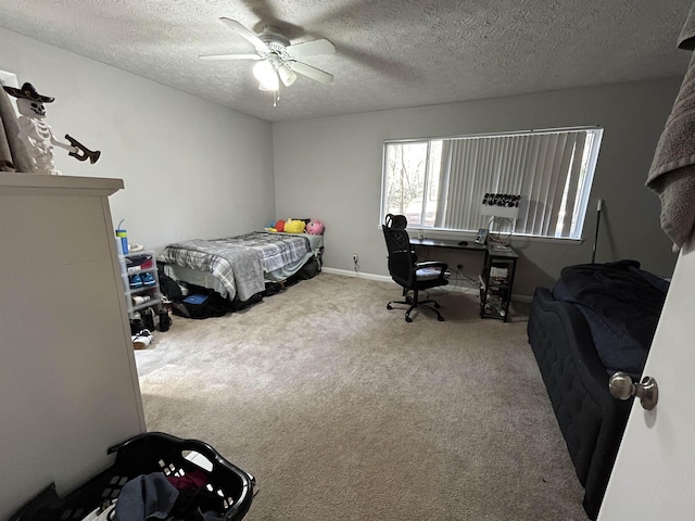 bedroom with ceiling fan, carpet floors, and a textured ceiling