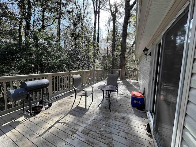 wooden deck featuring a grill