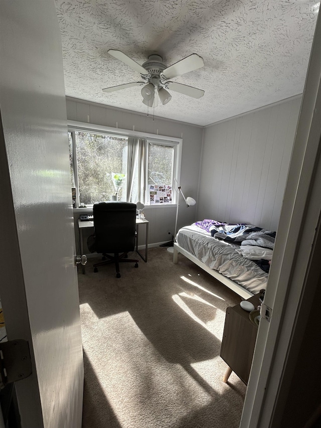 bedroom featuring carpet, a textured ceiling, and ceiling fan